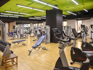 a gym with several treadmills and cardio machines at Ala Moana Honolulu by Mantra in Honolulu