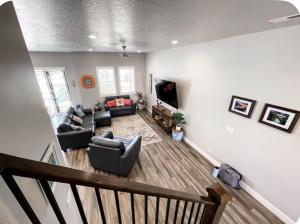 a living room with couches and a tv at Kantada in the Sun - Poolside Retreat in Santa Clara