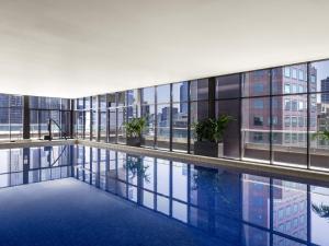 an indoor pool in a building with windows at Mantra Southbank in Melbourne