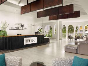 a lobby of the port island mall with a reception desk at Mantra PortSea in Port Douglas +108 photos
