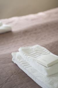 a white towel laying on top of a bed at Executive Living Old Town Unique in Stockholm +43 photos