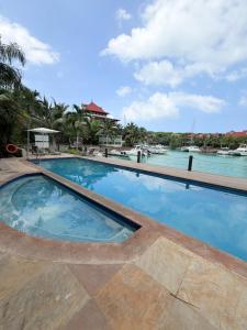 a swimming pool with blue water in a resort at Exotic Trove in Eden Island
