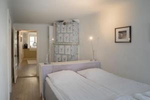 a bedroom with two white beds and a hallway at Executive Living Old Town Unique in Stockholm