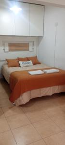 a bedroom with a large bed with white cabinets at Atenea B in Chivilcoy