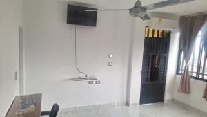 a room with a black door and a ceiling fan at Edificio Torre in Barrancabermeja
