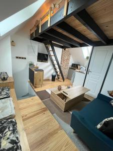a living room with a couch and a loft at République in Verberie