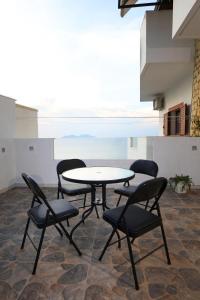 a table and chairs in a room with a table at Hill Suites in Vlorë