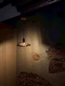 aendant light hanging from a room with a brick wall at 緩寓 Sora Apt包棟民宿2-8人 in Jiufen +53 photos