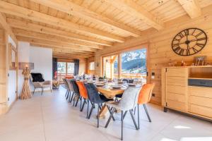 a dining room with a long table and chairs at Chalet BO'M in Le Grand-Bornand