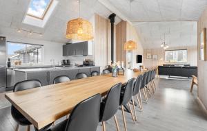 a dining room and kitchen with a wooden table and chairs at Beach Front Home In Bogense With Sauna in Bogense