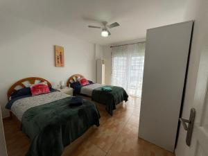 a bedroom with two beds and a window at La Cenia in Denia +7 photos