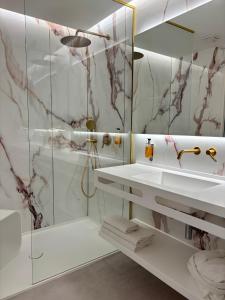 a bathroom with a sink and a shower at Belenus Thermalhotel in Zalakaros