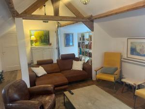 a living room with a couch and a chair at Gite La Cigogne in Couvin