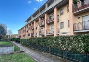 an apartment building with a fence in front of it at La casa di AngeLis in Stezzano