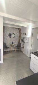 a living room with a table and a kitchen at γαληνη in Vamos