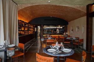a restaurant with tables and chairs and a man in the kitchen at Inspira Santos Boutique Hotel in Lisbon