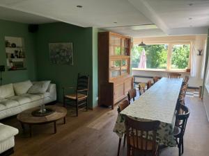 a living room with a table and a couch at Gite La Cigogne in Couvin
