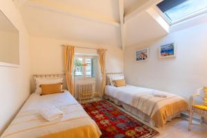 a bedroom with two beds and a window at Villa Blue Riviera & Le Joyau de la baie de Cannes in Cannes +39 photos