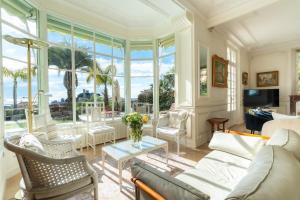 a living room with a couch and a table at Villa Blue Riviera & Le Joyau de la baie de Cannes in Cannes