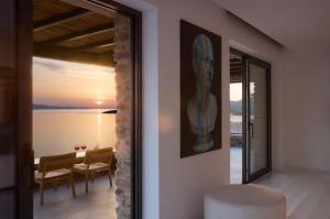 a room with a view of the ocean and a table at Villa Apollo in Kionia