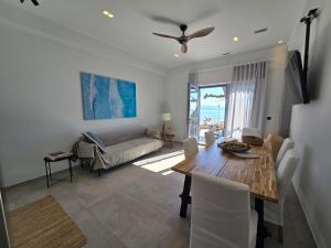 a living room with a table and a couch at Ilia Suites "Thalassa" in Ilia