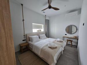 a bedroom with a bed and a ceiling fan at Ilia Suites "Thalassa" in Ilia