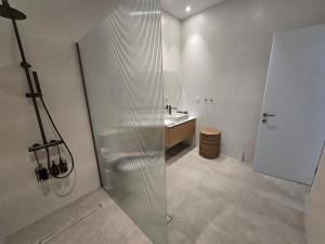 a bathroom with a shower and a sink at Ilia Suites "Thalassa" in Ilia +10 photos