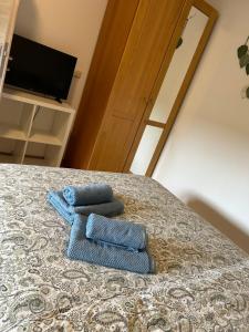 two blue towels sitting on top of a bed at Chambre double à Niederkorn in Differdange +43 photos
