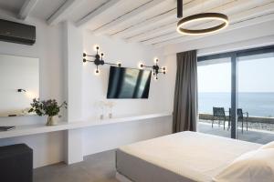 a bedroom with a bed and a view of the ocean at Villa Apollo in Kionia