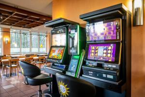 a room with two video game machines in a restaurant at Raststättenhotel Tecklenburger Land West in Tecklenburg