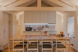 a kitchen with a table and chairs in a room at Bravia Country House in Fafião