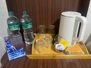 a tray with water bottles and glasses on a table at Hotel Atithi in Surkhet