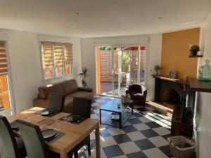 a living room with a table and a couch at Agréable maison avec SPA in Crécy-en-Ponthieu