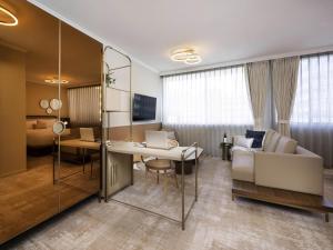 a hotel room with a bed and a desk with a laptop at Mantra Terrace Brisbane in Brisbane
