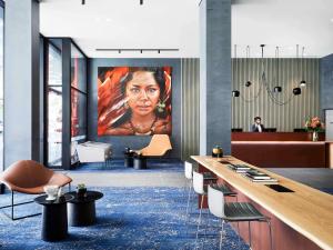a lobby with a large painting of a woman at The Adnate Perth - Art Series in Perth +146 photos
