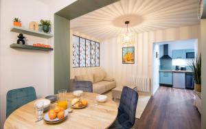 a dining room and living room with a table and chairs at Le Parvis in Rodez