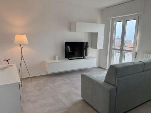 a living room with a couch and a television at Lake at Home in Lecco