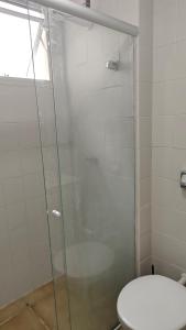 a bathroom with a glass shower with a toilet at Apto Centro Floripa 03 in Florianópolis