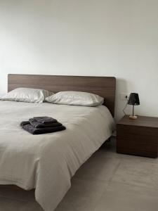 a bedroom with a large bed with a wooden headboard at Lake at Home in Lecco