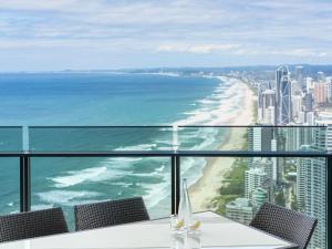 a table with chairs and a view of the ocean at Peppers Soul Surfers Paradise in Gold Coast