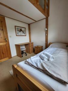 a bedroom with a bed with two towels on it at Haus Teelke in Papenburg