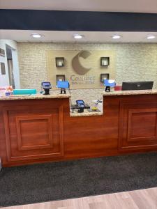 a lobby with a reception desk with blue chairs at Comfort Inn & Suites Dayton Northwest - Englewood in Dayton