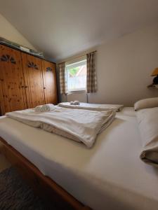 a large white bed in a room with a window at Haus Teelke in Papenburg