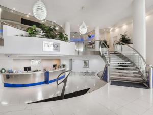a lobby with a spiral staircase in a building at Mantra Sirocco in Mooloolaba +77 photos