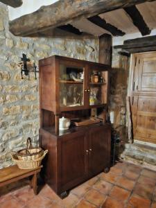 a wooden cabinet in a room with a stone wall at Casa de la Gallega in Bargota +45 photos