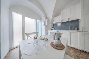 a kitchen with a table with two glasses on it at Borgo castello - trekking point - 8 min Sea - AC in Loano +16 photos