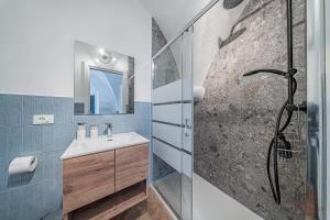 a bathroom with a shower and a sink and a mirror at Borgo castello - trekking point - 8 min Sea - AC in Loano