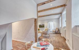 a living room with white walls and wooden beams at Munkler Mühle Whg 1 in Irrhausen