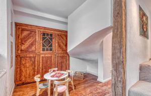 a room with a table and chairs and a staircase at Munkler Mühle Whg 1 in Irrhausen