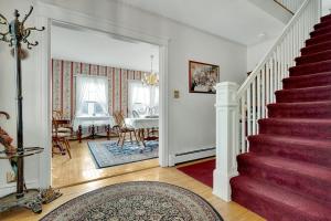 a living room with stairs and a dining room at The Nicholson Inn in Freeport
